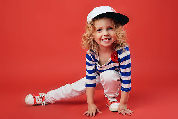 Portrait of a cute little girl in fashionable clothes Portrait of a cute little girl in fashionable clothes rap kid stock pictures, royalty-free photos & images