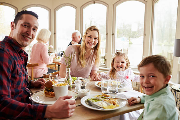 istock Family Enjoying Meal In Restaurant Together 524162876