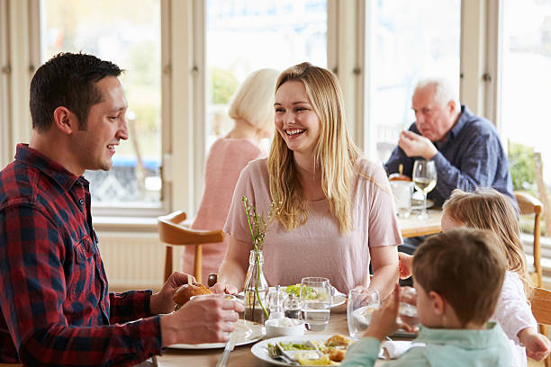 istock Family Enjoying Meal In Restaurant Together 524162894