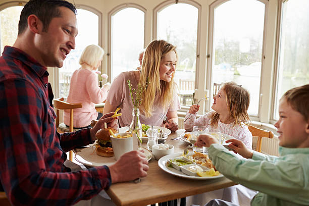 istock Family Enjoying Meal In Restaurant Together 524162938