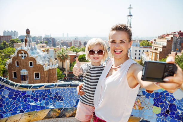 istock Mother and baby taking selfie with camera at Park Guell 524163700