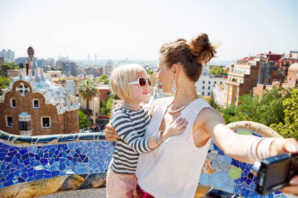istock Mother and baby taking selfie with camera at Park Guell 524163744