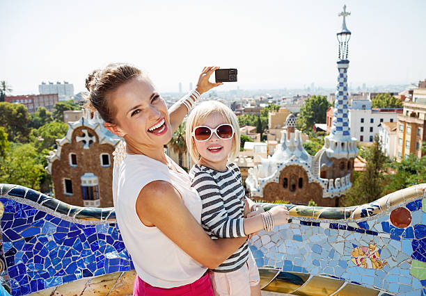 istock Mother and baby taking photos with camera at Park Guell 524163878