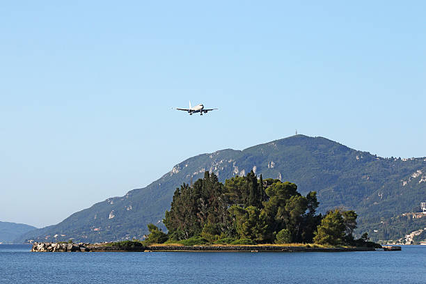 istock airplane flying over Mouse island Corfu Greece 524164704
