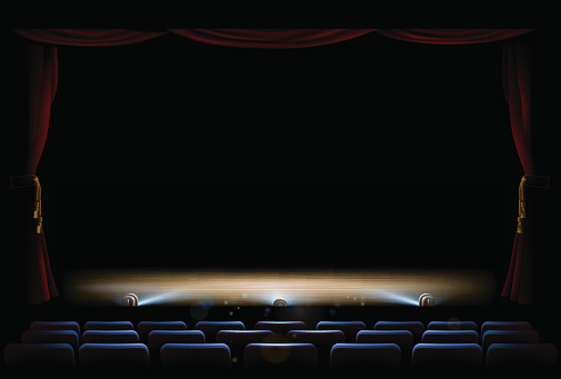 An illustration of the interior of a theatre with stage, footlights and curtains