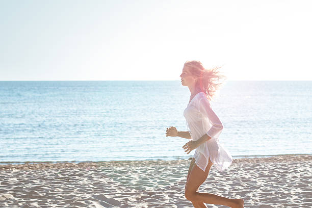 istock Attractive young woman jogging on the beach 524167464