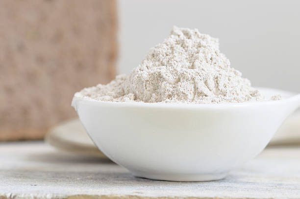 istock Bowl with flour on a wooden table and bread. 524167754