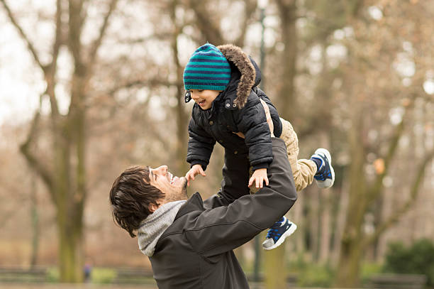 istock Joyful father and son having fun in park 524168792