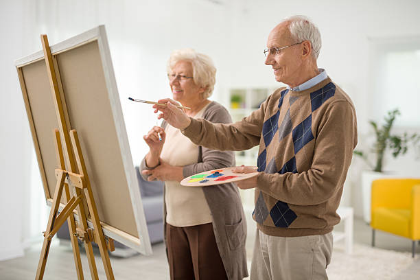 istock Older man and woman painting on canvas 524168796