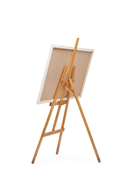 Wooden easel with a canvas on it Rear view vertical shot of a wooden easel with a canvas on it isolated on white background easel stock pictures, royalty-free photos & images