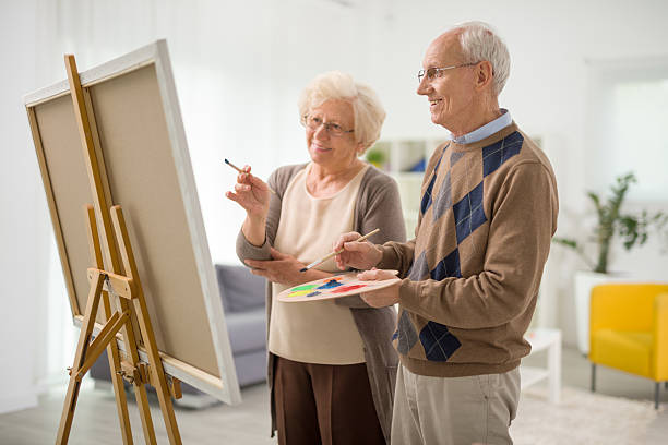 istock Senior couple drawing together on canvas 524169044