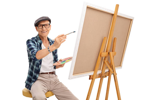 istock Senior artist painting on a canvas 524169538