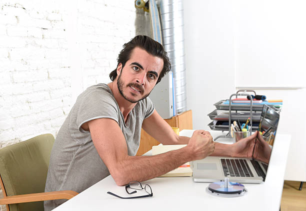 istock hipster student or businessman working in stress at home office 524169944