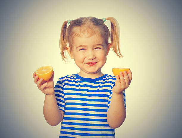 istock Little Funny girl keeps lemons 524170276