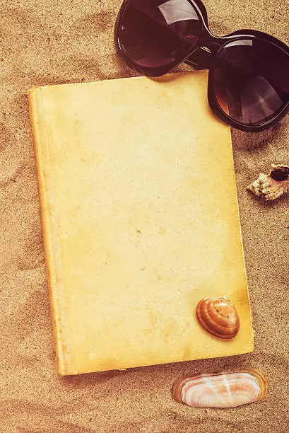 Photo of Reading favourite old book on summer vacation beach holiday