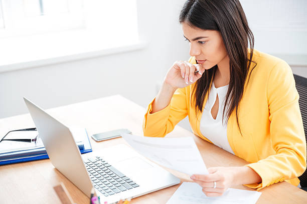 istock Businesswoman working with documents and laptop 524171118