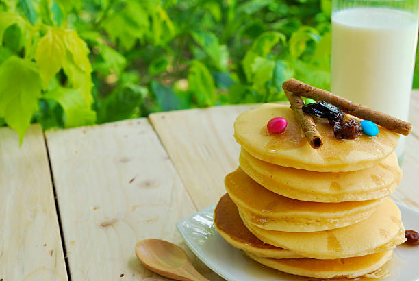 istock Stack of pancakes and syrup in plate on wooden table 524171509