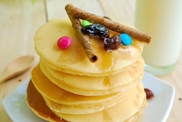 istock Stack of pancakes and syrup in plate on wooden table 524171589
