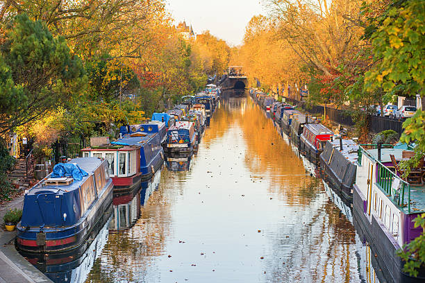 Little Venice district in West London Rows of houseboats and narrow boats on the canal banks at Little Venice, Paddington, West London, on a brigh fall day little venice london stock pictures, royalty-free photos & images