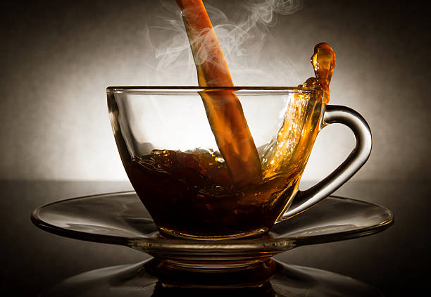istock Pour coffee into transparent glass cup with dark background. 524172163