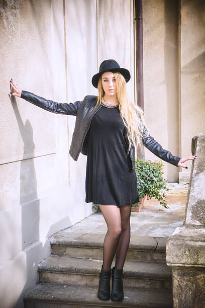 istock Beautiful young woman in black hat 524172418
