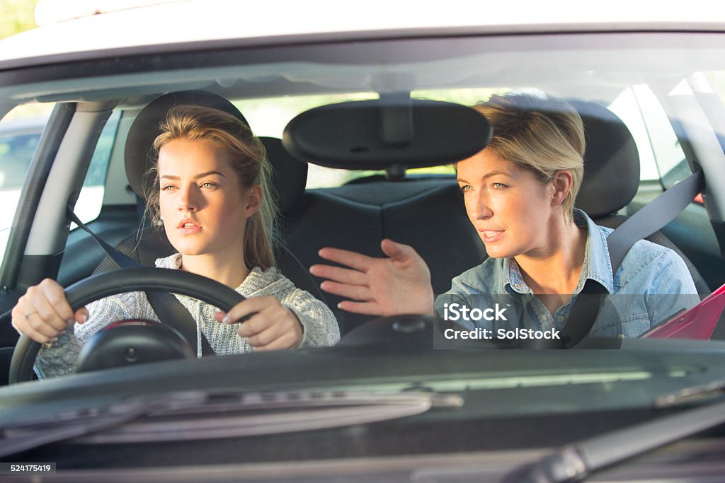 Learning to Drive Young Girl Taking Driving Lessons with an Instructor L Plate Stock Photo