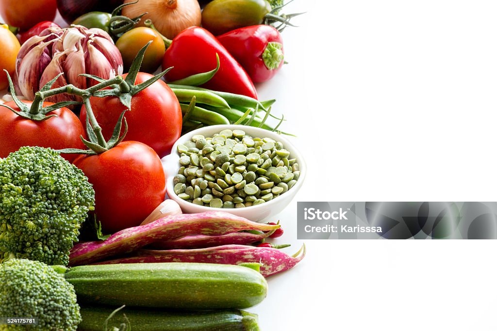 Green peas in and vegetables on a white background Green peas in a bowl and vegetables on a white background Bean Stock Photo