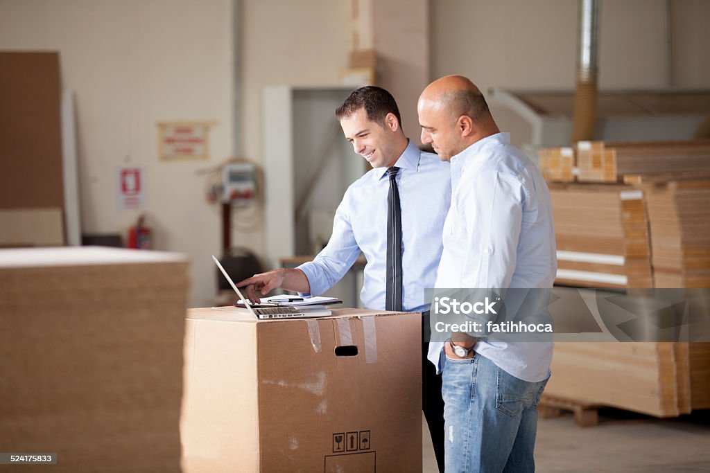 Small Business Two businessman working in factory. Business Stock Photo