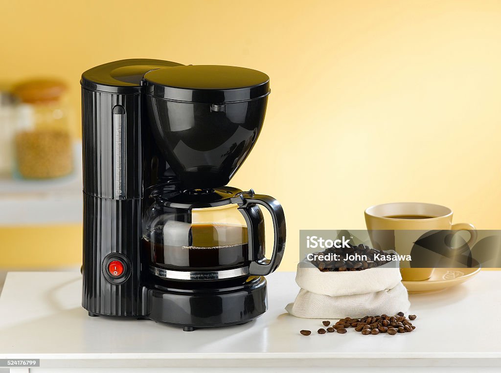 Coffee blender and boiler with coffee seeds in a kitchen Coffee blender and boiler with coffee seeds in a kitchen interior Coffee Maker Stock Photo