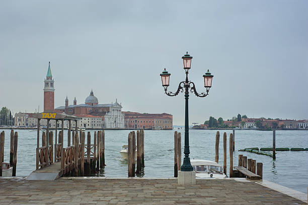 Water taxi stop Venice at dawn with the lagoon and San Giorgio de Maggiore in the background