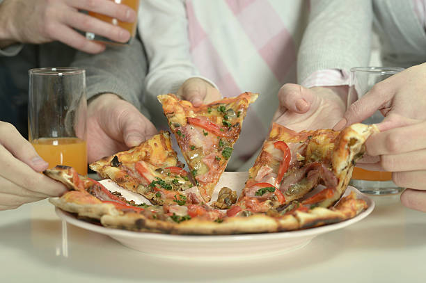 istock family at home with pizza 524177060