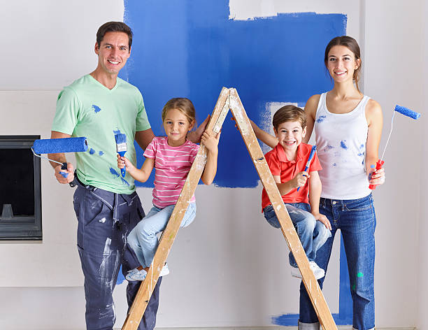 istock Family painting wall blue together 524178972