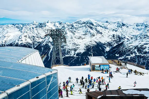 Skiers on top of ski resort Soelden - Gaislachkogl (3.058 m), Tirol, Austria before skiing down the slope.