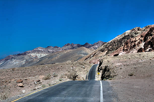 Yellow Road sign - USA desert road - Mountains stock photo