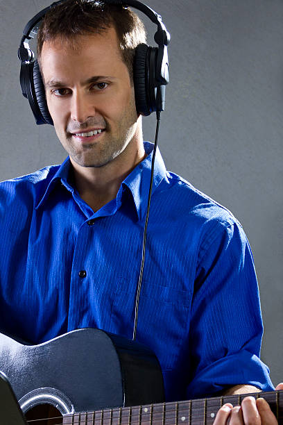 istock Male Guitar Player in Recording Studio 524196719