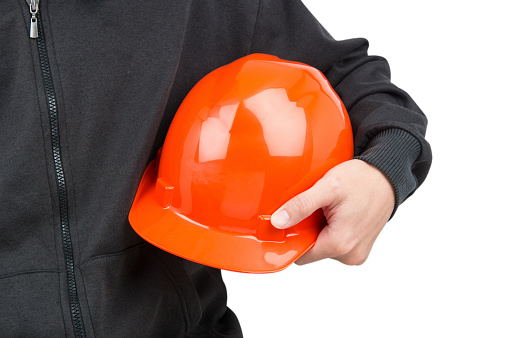 hard hat holding by construction worker on white background
