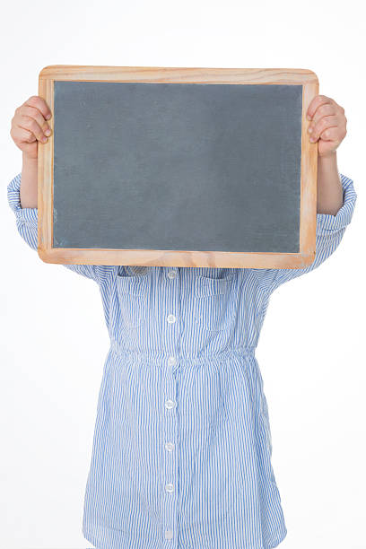 hide and seek girl young kid with her face behind blackboard person holding frame over face stock pictures, royalty-free photos & images