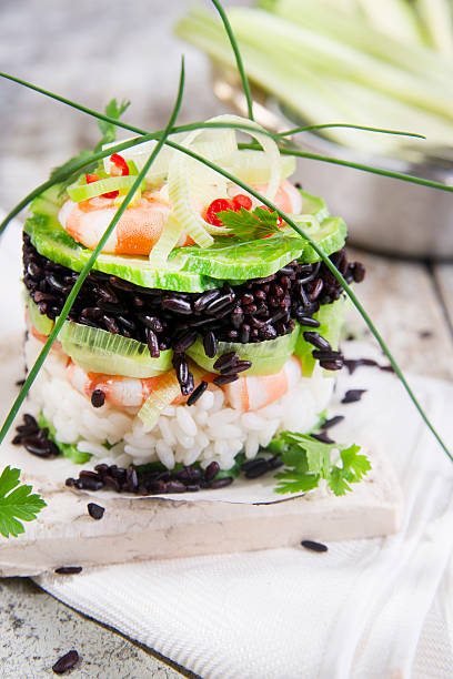 istock Tower of black and white rice with shrimp and zucchini 524200413