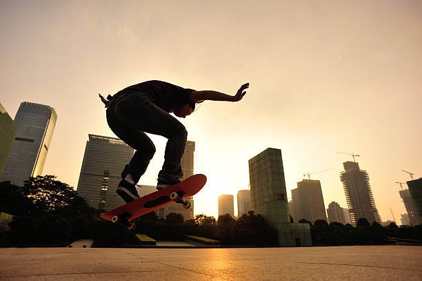 istock skateboarding woman jumping at  sunrise 524200799