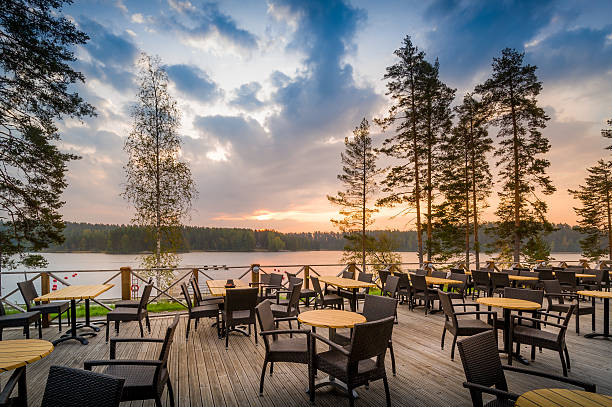 Cafe del lake sunset Romantic sunset at outdoor restaurant. Northern forest and lake. etela savo finland stock pictures, royalty-free photos & images