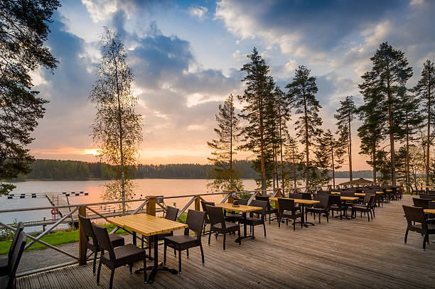Cafe del lake sunset Romantic sunset at outdoor restaurant. Northern forest and lake. etela savo finland stock pictures, royalty-free photos & images