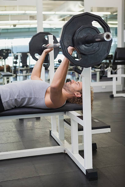 istock Young muscular man lifting barbell in gym 524202241