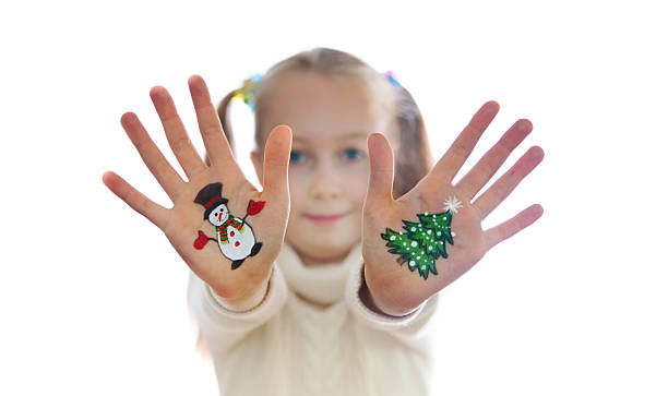 istock Christmas tree and Snow man painted on kid's hands 524202501