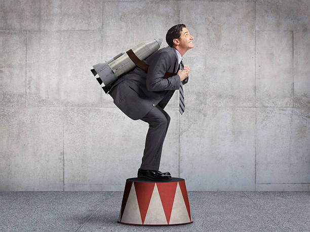 Businessman Preparing For Takeoff On Circus Pedestal