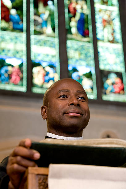 istock Priest Reading from Bible on Church Altar 524203229