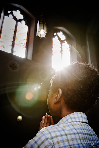 The sunlight shines beautifully through the windows of an old church in Munich, Germany.
