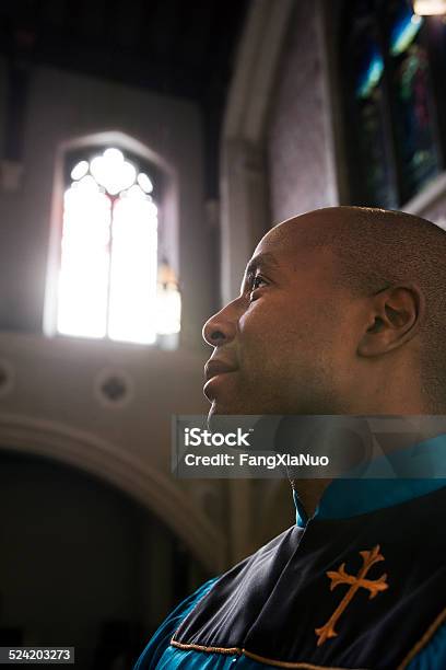 Male Church Member Praying During Service Stock Photo - Download Image Now - Minister - Clergy, Clergy, Church