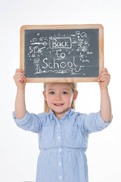 istock happy child with smock and blackboard 524227273