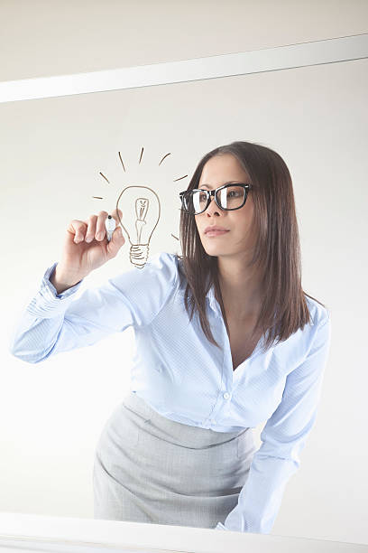 istock Business woman drawing light bulb 524227929