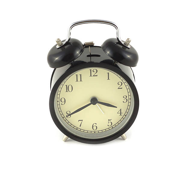 istock Alarm clock in black case shows about four o'clock 524228807